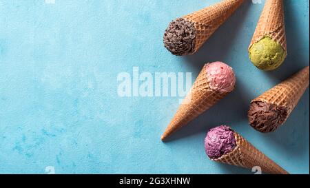 Ice cream scoops in cones with copy space on blue Stock Photo