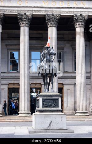 Equestrain Statue of Arthur Wellesley, the 1st  Duke of Wellington outside the Gallery of Modern Art, Glasgow.The traffic cone on his head is a tradit Stock Photo