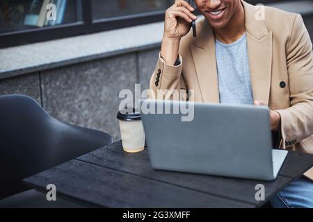Close up of freelancer having pleasant conversation Stock Photo
