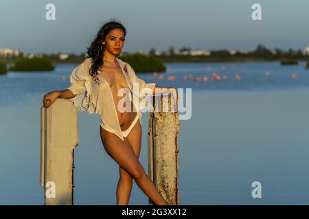 A Lovely Latin Model Poses With The Rising Sun On A Romantic Caribbean Beach Stock Photo