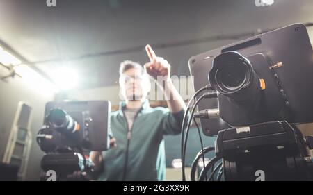 Cameraman operates a film camera, broadcasting recording studio Stock Photo