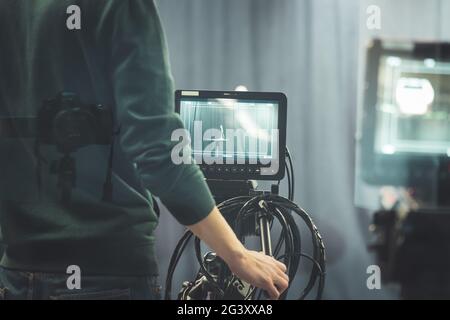 Cameraman operates a film camera, broadcasting recording studio Stock Photo