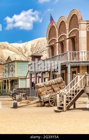 Vintage Far West town with saloon. Old wooden architecture in Wild West. Stock Photo