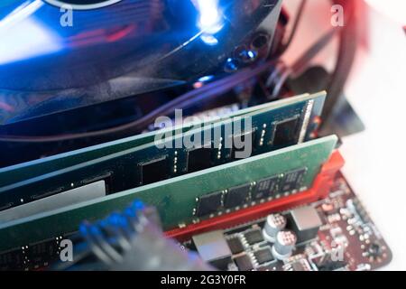 inserting plug in the ram ddr memory card in the computer mainboard, random access memory Stock Photo