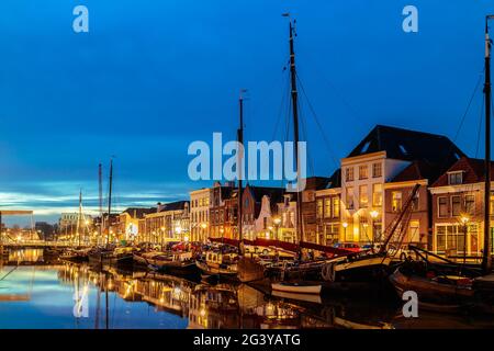 Evening view of a Dutch canal with sailing boats in the city center of Zwolle Stock Photo