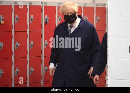 Prime Minister Boris Johnson enters the automotive shop during a visit to Kirklees College Springfield Sixth Form Centre in Dewsbury, West Yorkshire. Picture date: Friday June 18, 2021. Stock Photo