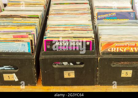 Den Bosch, The Netherlands - May 12, 2019: Wooden boxes with vinyl turntable records on an antique fifties to seventies flea market in Den Bosch, The
