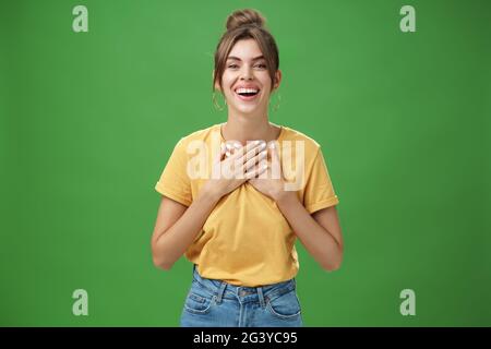 Delighted charming woman with gapped teeth in cozy outfit holding palms on  chest in grateful or thankful pose smiling broadly receiving warm Stock  Photo - Alamy