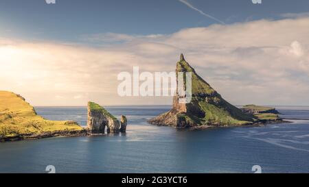 Drangarnier rock formations and Tindholmur island in sunset on Vagar ...