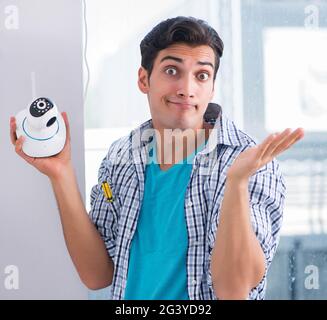 Man installing surveillance CCTV cameras at home Stock Photo