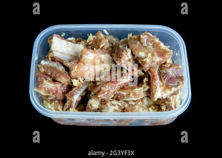 Fresh pork ribs mix with garlic and pepper on black background. Stock Photo