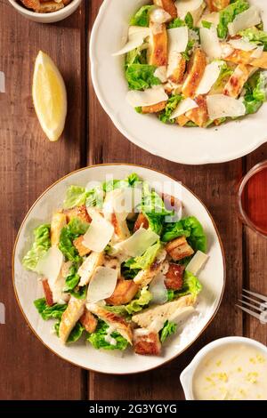 Caesar salad a dark rustic wooden table Stock Photo