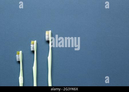 Yellow toothbrushes on navy blue background. top view, copy space Stock Photo