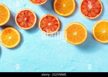 Summer background with fresh oranges on a blue background Stock Photo