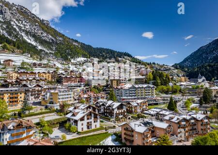 The Improbable aerial landscape of village Molveno, Italy, snow covered mountains Dolomites on background, roof tops of chalet, Stock Photo