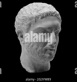 Head detail of the ancient man sculpture. Stone face isolated on black background. Antique marble statue of mythical hero charac Stock Photo