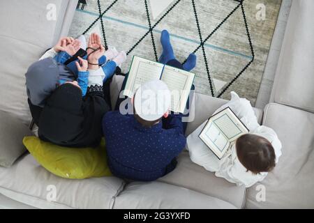 Top view of young muslim family reading Quran during Ramadan Stock Photo