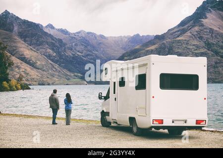 RV motorhome camper van road trip young people on New Zealand travel vacation adventure, Two tourists looking at lake and mountains on pit stop next Stock Photo