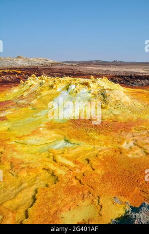 Ethiopia; Afar region; Danakil Desert; Danakil Depression; Dallol geothermal area; hot sulfur springs; cone-like formation in intense yellow, red and Stock Photo