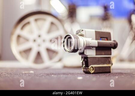 Movie production: vintage old movie camera on the floor, production studio in the background Stock Photo