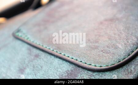 Detail of a fashionable leather bag close up. Fashion concept. Details of sewing threads, macro photography. Stylish female accessory Stock Photo