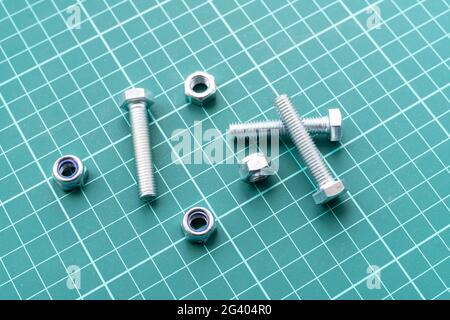 silver stainless steel nuts and bolts flat lay on the table, minimalistic concept Stock Photo