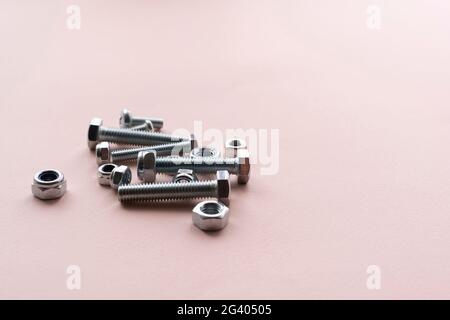 silver stainless steel nuts and bolts flat lay on the table, minimalistic concept Stock Photo