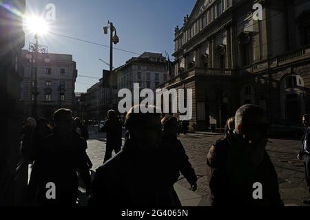 People walk in La Scala square, with the historical theater building, in downtown, Milan, Italy. Stock Photo