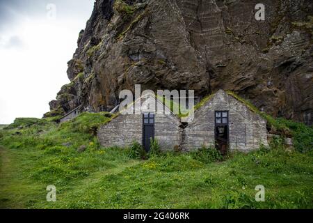 Drangurinn Rock, a mysterious giant boulder, sits below the EyjafjÃ¶ll Mountains Stock Photo