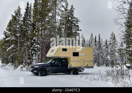 Motorhome in deep snow in the forest in Lapland, Suddesjaur, Sweden Stock Photo