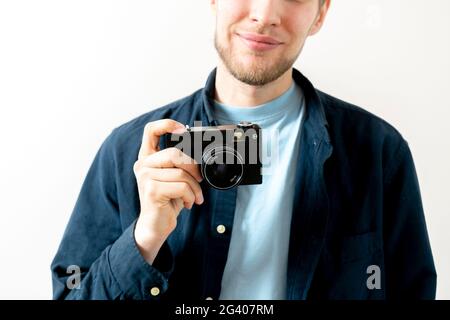 happy person holding a vintage old camera and making photos Stock Photo