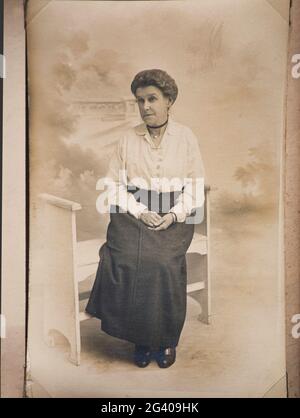 1910's Authentic vintage photograph of senior woman sitting posing for studio shot. Concept of nostalgia, vintage, historic Stock Photo