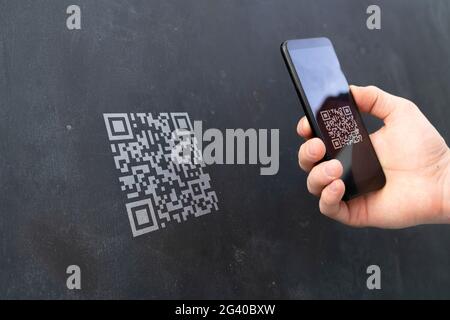 hand holding a smartphone and scan the qr code to make a payment Stock Photo