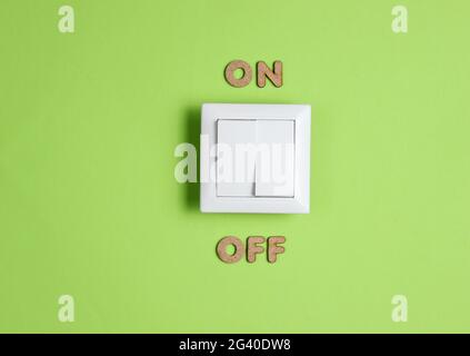 Light switch with on off word on green background Stock Photo