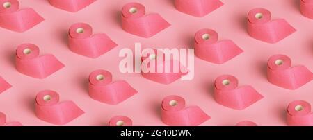 Rolls of pink toilet paper on pink background. panoramic pattern Stock Photo