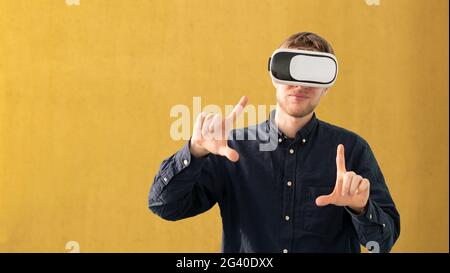 young man using futuristic virtual reality glasses, vr technology Stock Photo