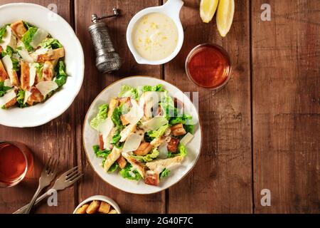 Caesar salad, shot from above on a dark rustic wooden background Stock Photo