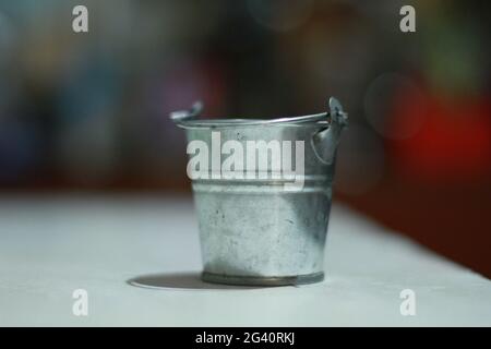 small iron bucket close-up on the table Stock Photo
