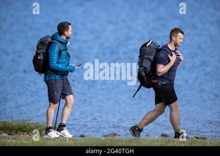 Buttermere, England. June 15 2021. Fell walkers strolling along the shore of Buttermere. Stock Photo