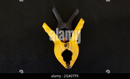 Two Plastic Clamps on a Black Background Stock Photo
