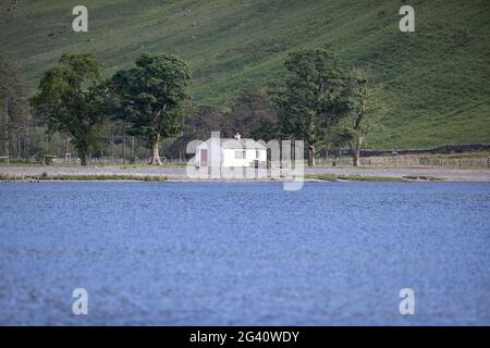 Buttermere, Cumbria, England. 15 June 2021. A white building sits on the edge of Buttermere lake. Stock Photo