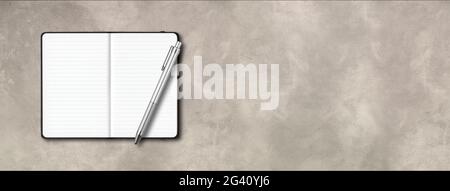 Black open lined notebook with a pen isolated on concrete background. Horizontal banner Stock Photo