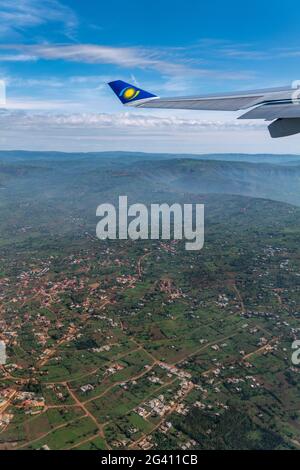 View out of window of a RwandAir Airbus A330-300 airplane with sun logo on winglet, on the flight from Kigali International Airport (KIG) in Rwanda, A Stock Photo
