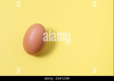 Egg isolated on yellow background. Image with copy space Stock Photo