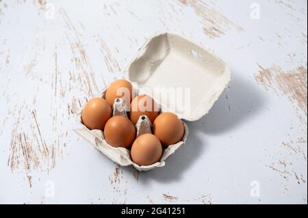 Egg cup with half a dozen eggs. Organic eggs from free-range hens Stock Photo