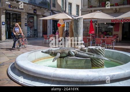 Public fountain in Nimes, France of the city's symbol, the crocodile.  It is believed that Julius Caesar, or perhaps Augustus as no one really knows, Stock Photo