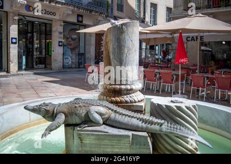 Public fountain in Nimes, France of the city's symbol, the crocodile.  It is believed that Julius Caesar, or perhaps Augustus as no one really knows, Stock Photo