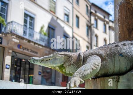 Public fountain in Nimes, France of the city's symbol, the crocodile.  It is believed that Julius Caesar, or perhaps Augustus as no one really knows, Stock Photo