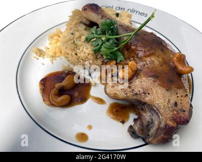 Duck confit with cashew nuts and rice dish in Restaurant Le Carré D´art upstairs of Carré d'Art contempory art museum, Nimes Gard department, Occitani Stock Photo