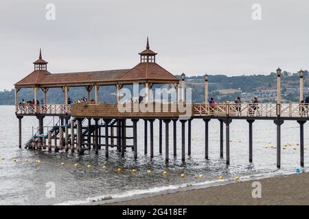 FRUTILLAR, CHILE - MARCH 1, 2015: People visit a pier in Frutillar village. Stock Photo